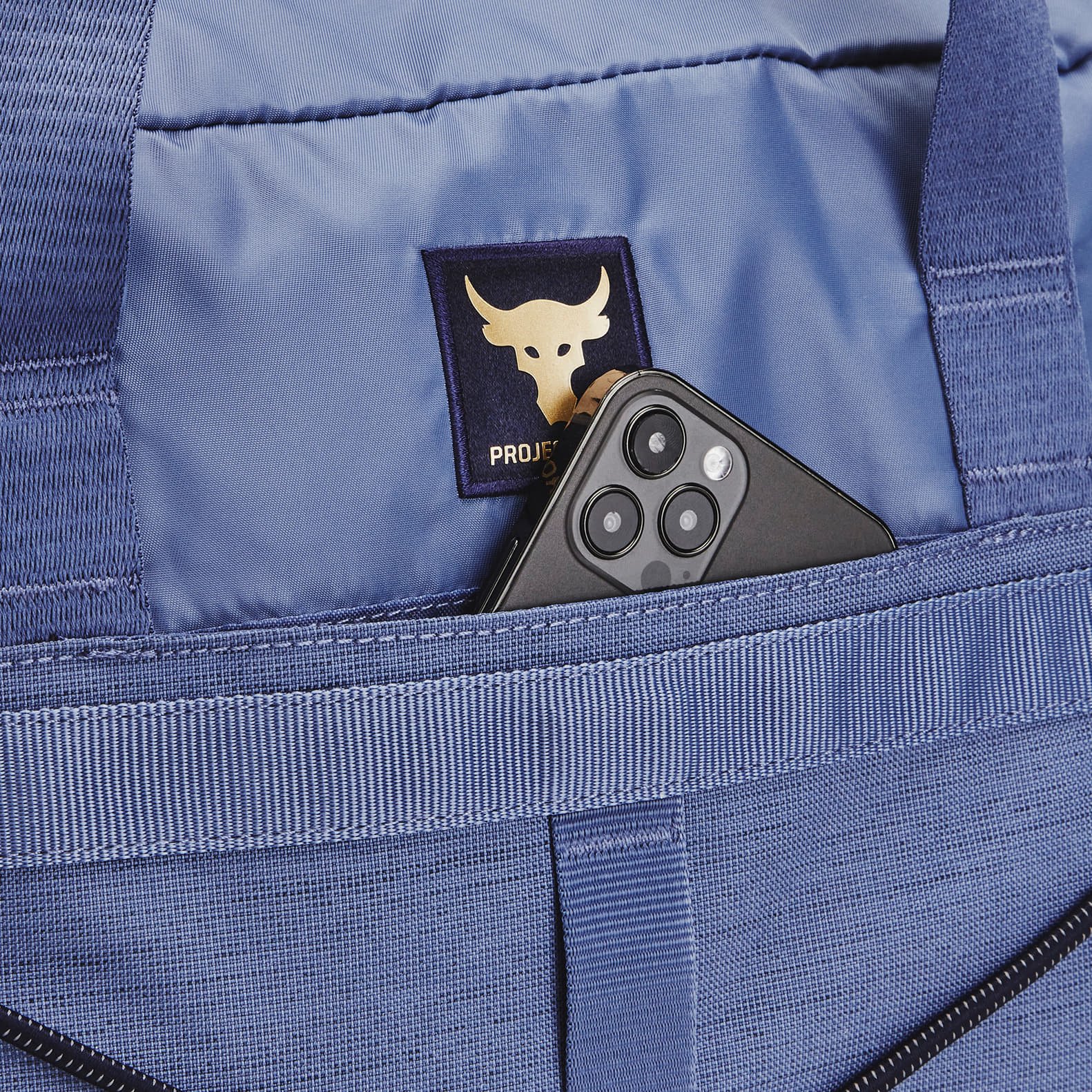 Tašky cez rameno Under Armour Project Rock Gym Bag Sm Hushed Blue/ Midnight Navy/ Metallic Gold