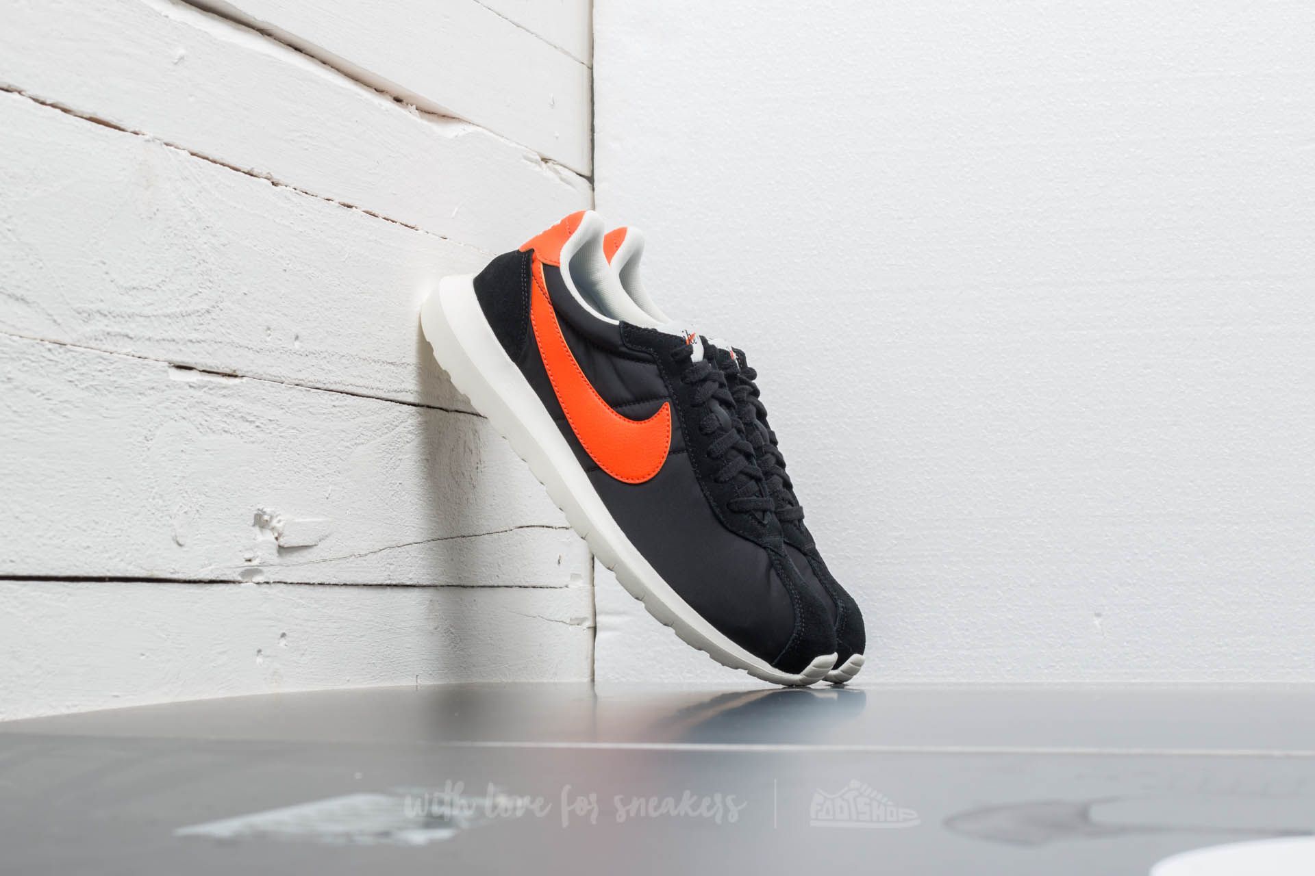 Black nike shoes with orange swoosh best sale