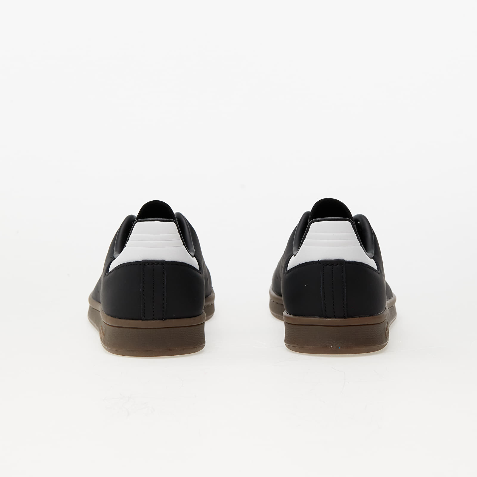 White sneakers with top black strap
