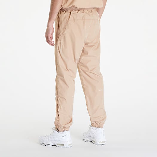 Pants and jeans Nike x NOCTA Woven Track Pants Hemp Sanddrift Footshop