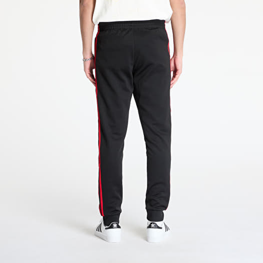 black adidas pants with red stripes