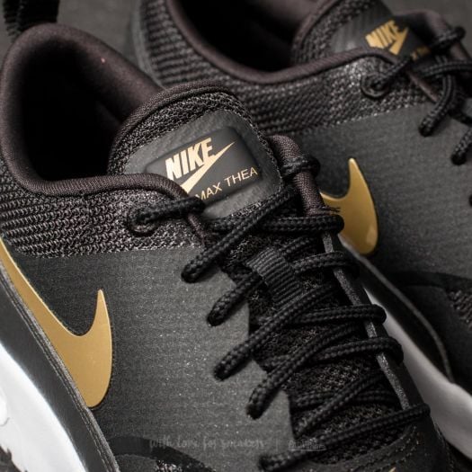 Nike thea black and gold sales