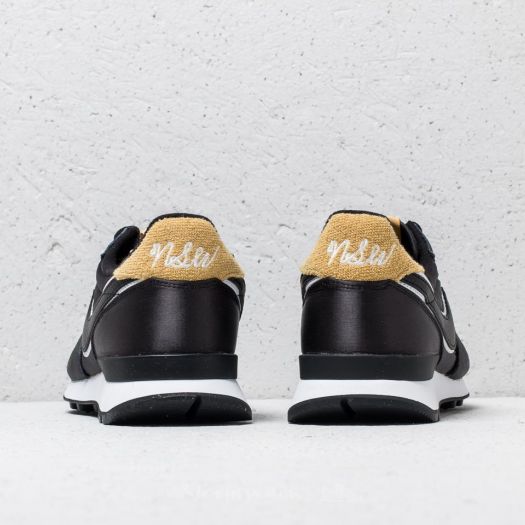 Nike black and best sale gold internationalist sneakers