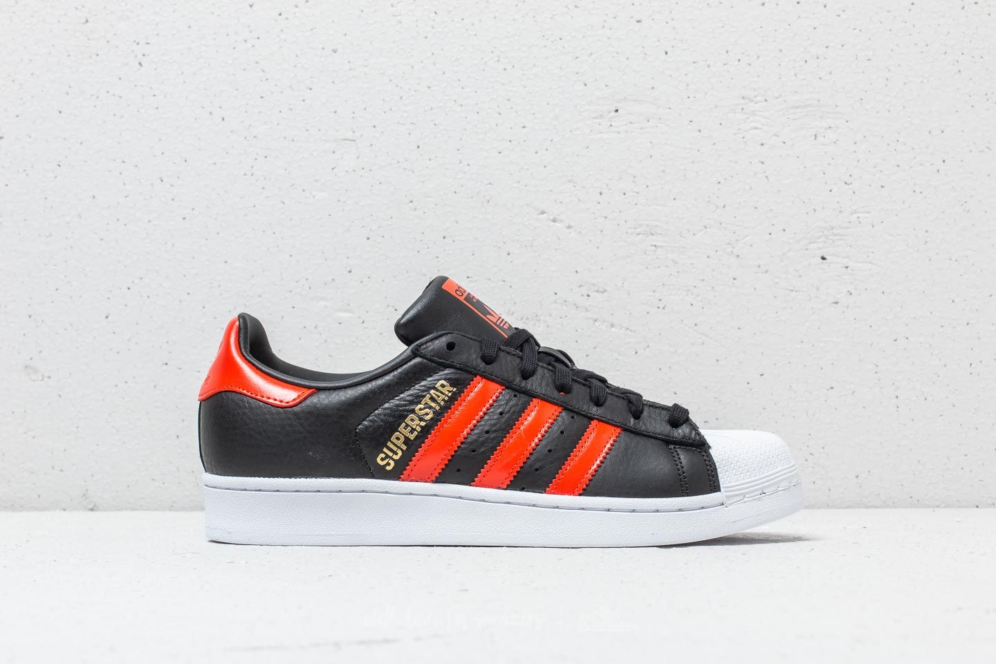 Black and orange adidas superstars on sale