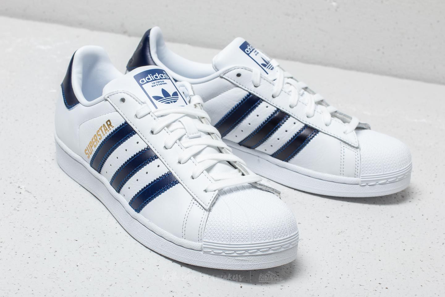 Superstar white navy gold top