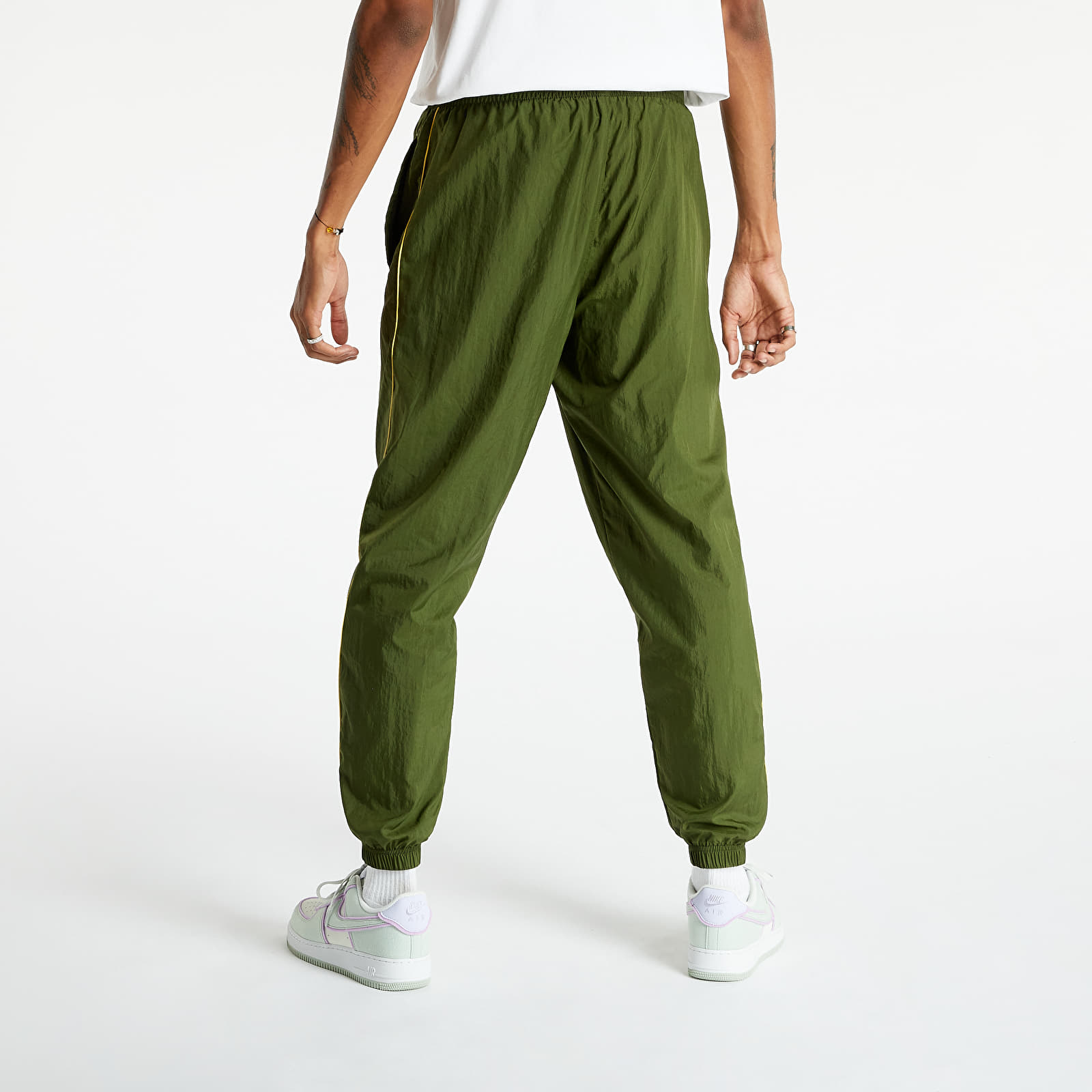 Nike track hotsell pants green